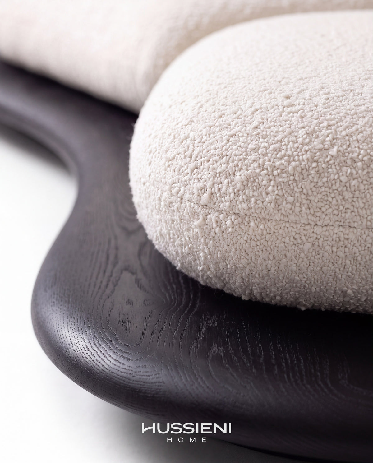 VOLUTA boucle seat and dark wood base detail