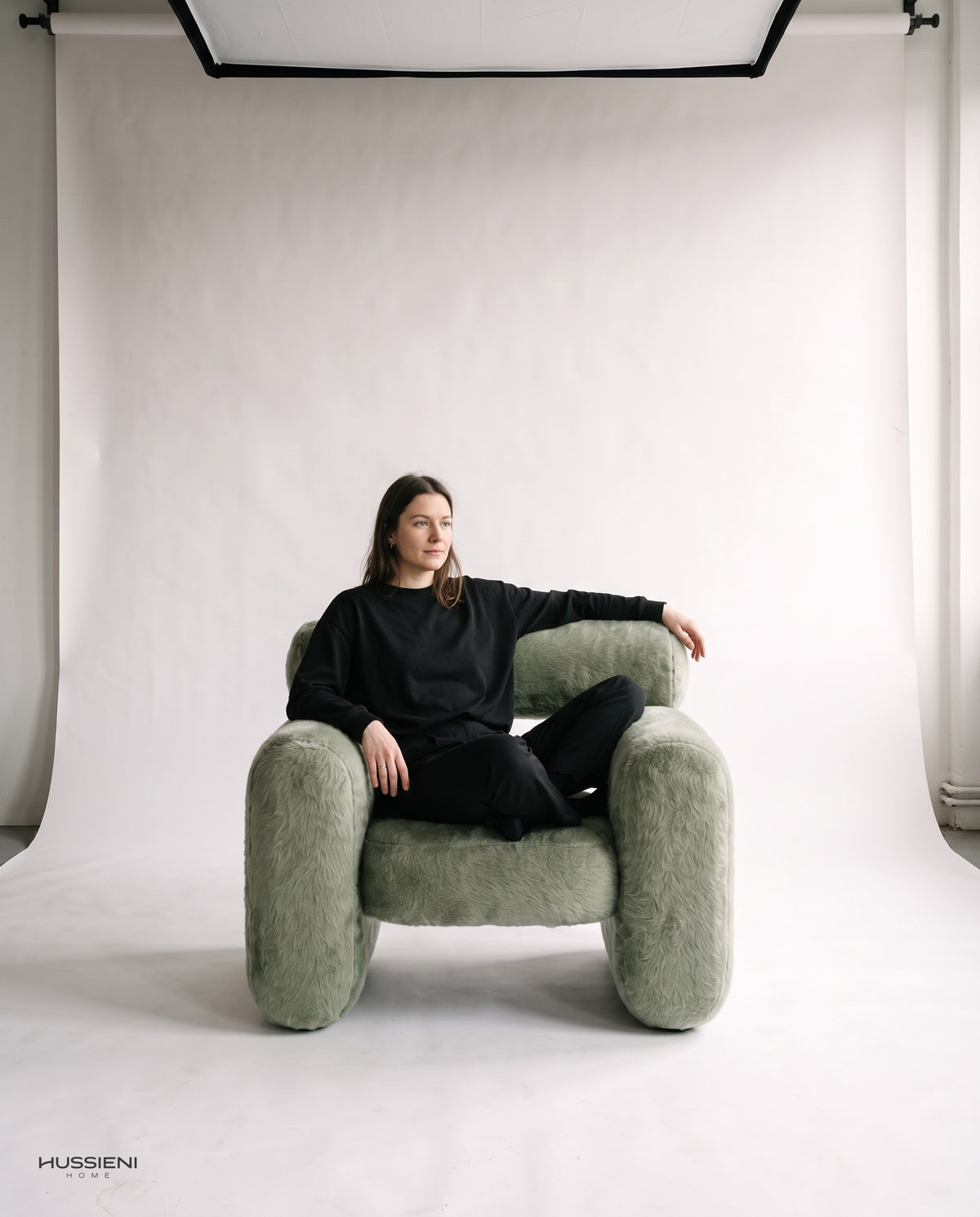 Capsule Lounge Armchair with model seated